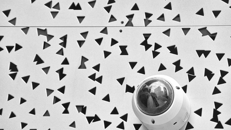 Dome CCTV camera mounted on a patterned wall
